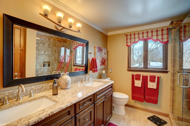 bathroom with a shower with door, vanity, wood-type flooring, ornamental molding, and toilet