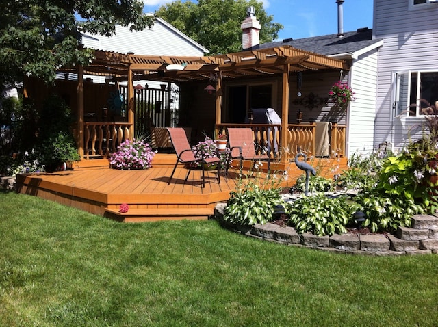 deck featuring a yard and a pergola