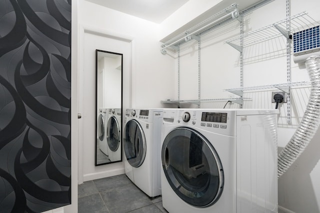 clothes washing area featuring washer and clothes dryer