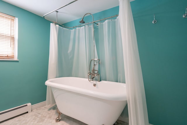 bathroom with baseboard heating and a tub to relax in