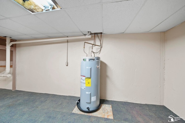 basement featuring carpet floors, a paneled ceiling, and water heater