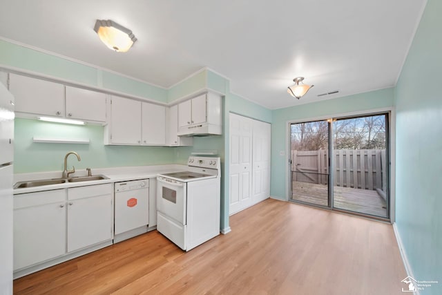 kitchen featuring white cabinetry, sink, white appliances, and light hardwood / wood-style flooring