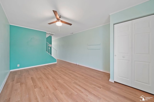 interior space featuring crown molding, light hardwood / wood-style flooring, and ceiling fan