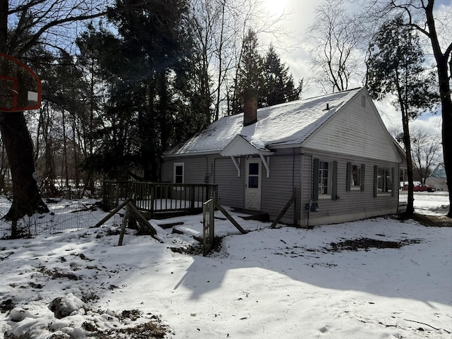 view of snow covered exterior featuring a wooden deck