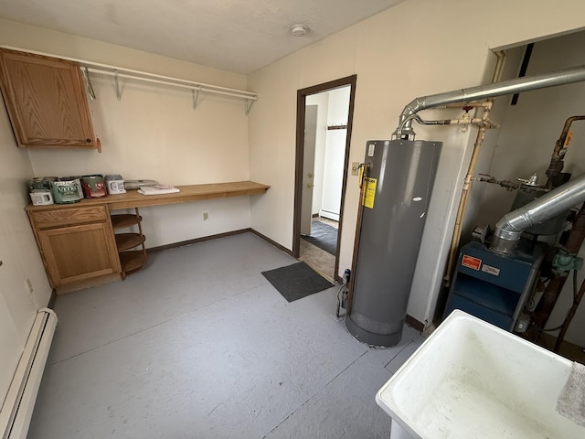 basement with gas water heater, sink, and a baseboard radiator