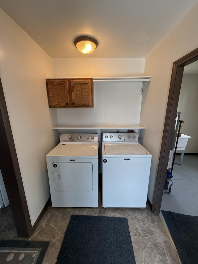 laundry room featuring cabinets and washer and dryer