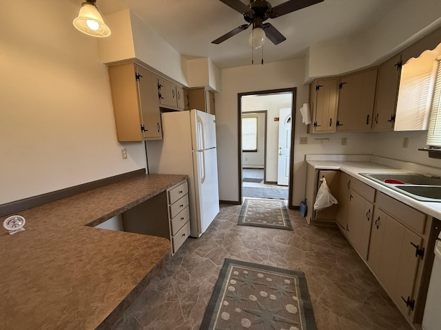 kitchen with white fridge, sink, a wealth of natural light, and cream cabinets