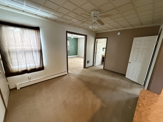 unfurnished room with light carpet, a baseboard heating unit, ornamental molding, and ceiling fan