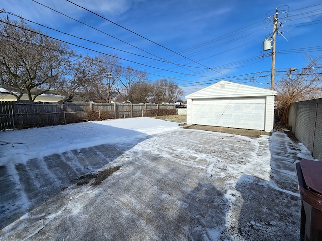 snowy yard with an outbuilding and a garage