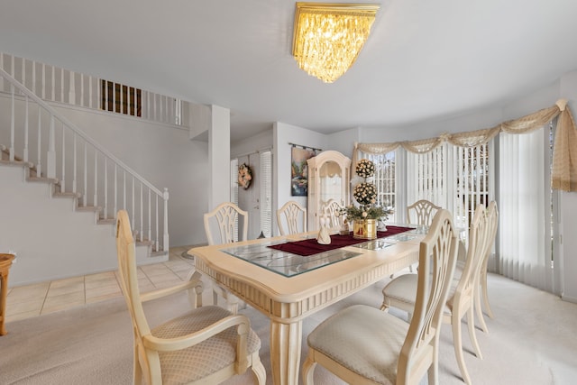 dining space featuring light tile patterned flooring and a notable chandelier