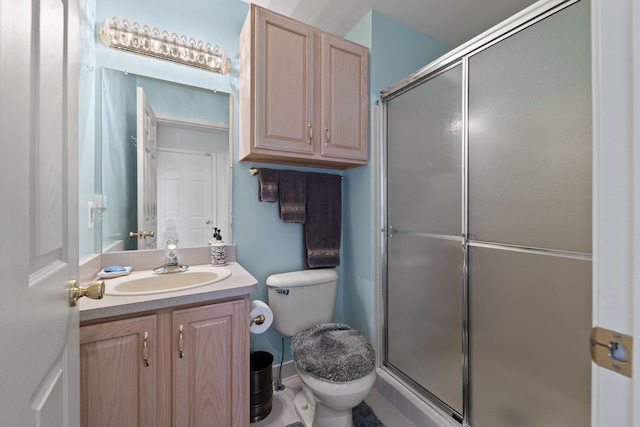 bathroom featuring an enclosed shower, vanity, and toilet