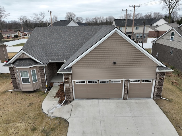 view of front of house featuring a garage and a front lawn