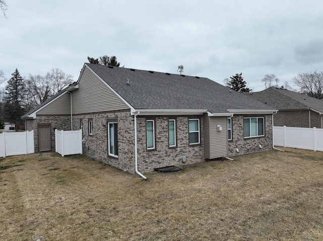 rear view of property with a yard