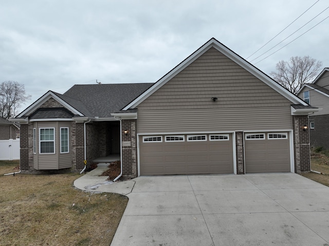 view of front of property with a garage and a front yard