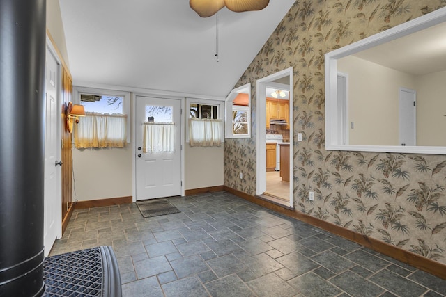 entrance foyer with ceiling fan and vaulted ceiling