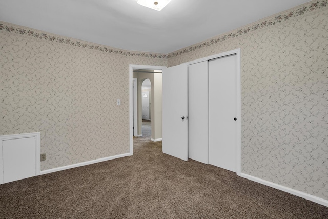 unfurnished bedroom with a closet and carpet flooring