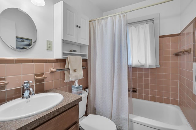 full bathroom featuring vanity, tile walls, shower / tub combo, and toilet