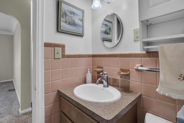 bathroom with vanity, tile walls, and toilet