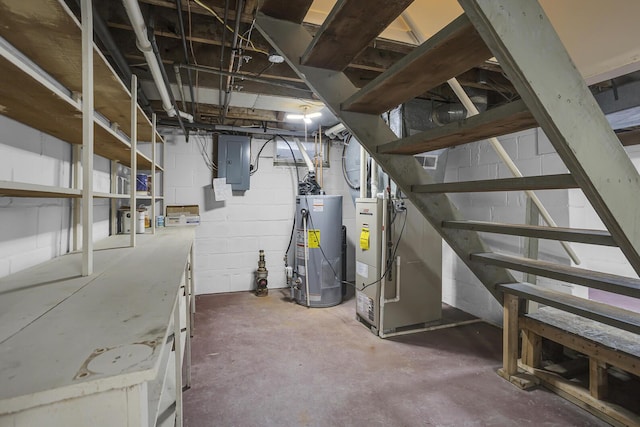 basement with gas water heater, heating unit, and electric panel