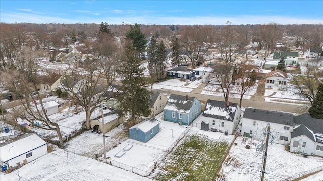 snowy aerial view with a residential view