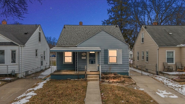 bungalow-style home featuring covered porch and a shingled roof