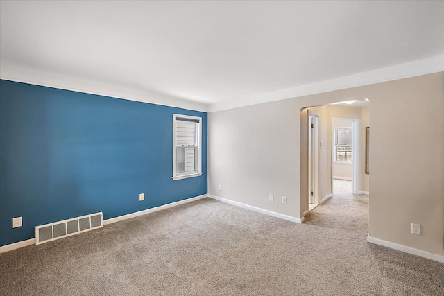 unfurnished room featuring light colored carpet