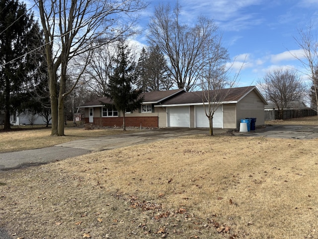 view of front of property with a garage and a front lawn