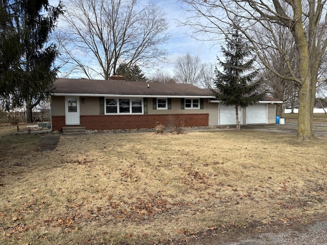 single story home with a garage and a front lawn