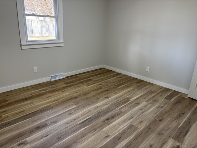 unfurnished room with dark hardwood / wood-style flooring