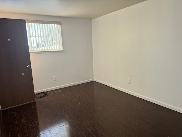 empty room featuring dark hardwood / wood-style flooring