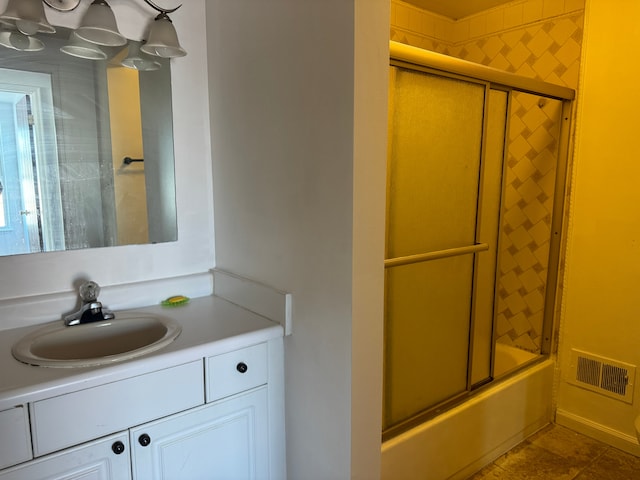 bathroom featuring shower / bath combination with glass door, vanity, and tile patterned floors