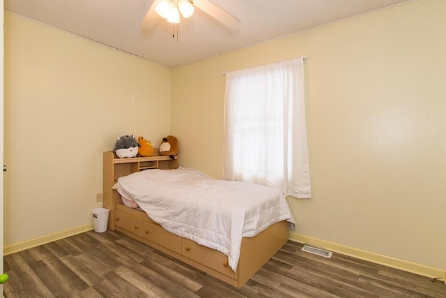 bedroom with dark hardwood / wood-style floors and ceiling fan