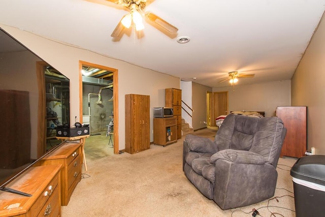 carpeted living room featuring ceiling fan