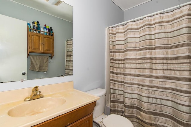 bathroom featuring vanity, toilet, and a shower with shower curtain