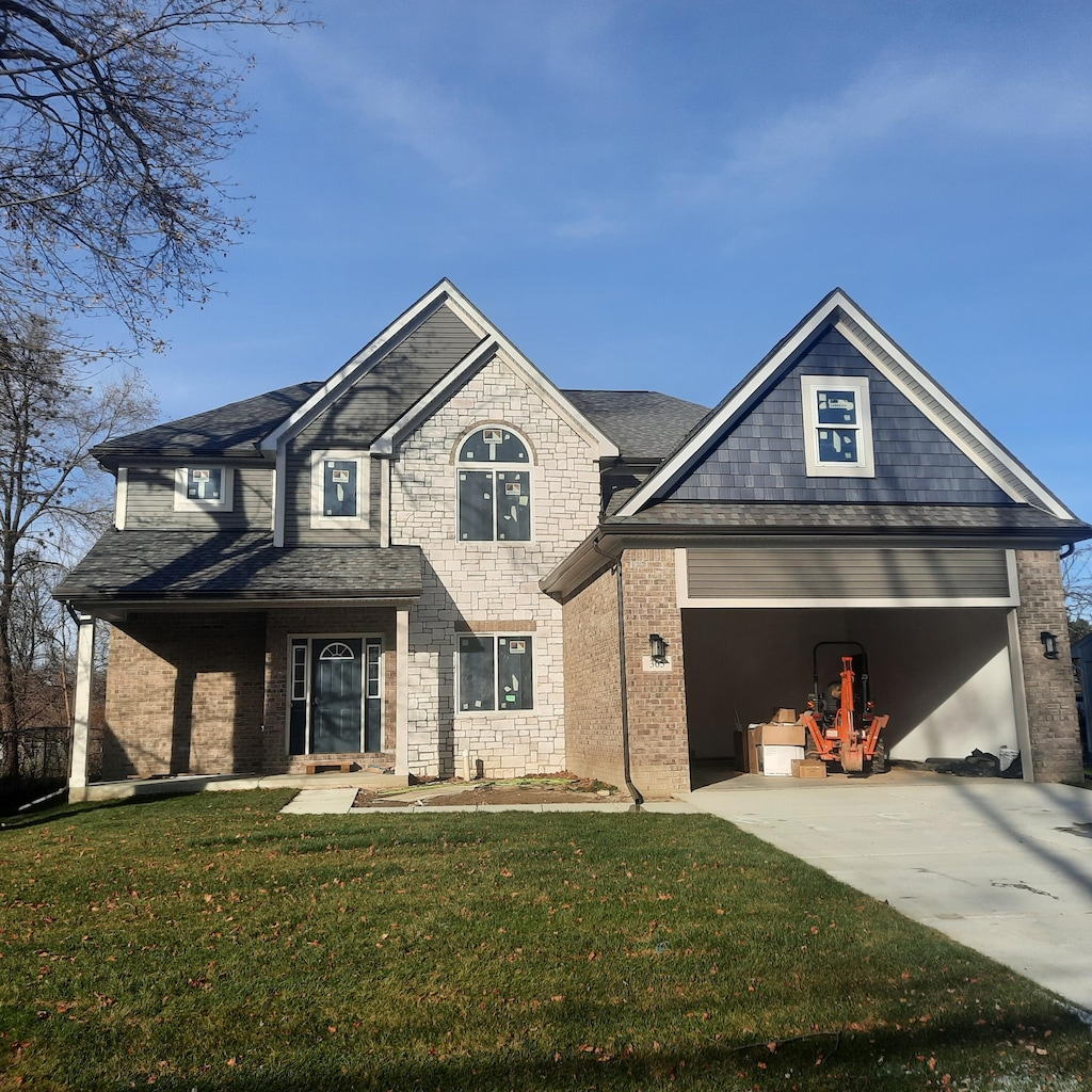 view of front facade featuring a garage and a front lawn