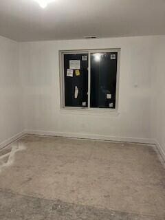 empty room featuring baseboards