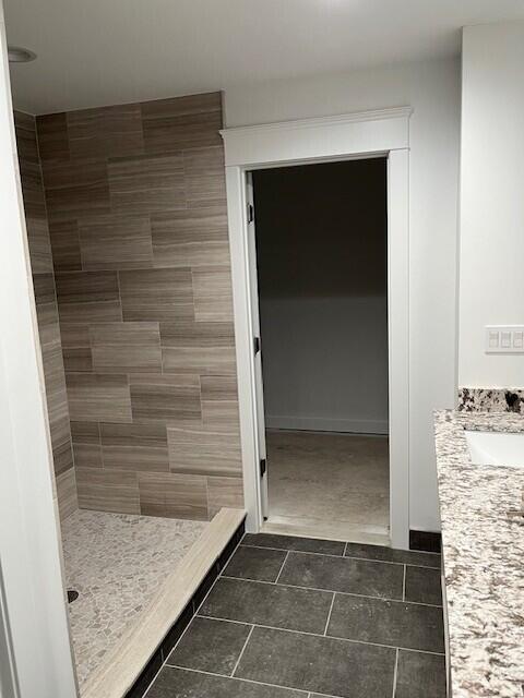 bathroom featuring a stall shower and vanity