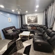 home theater room with ceiling fan