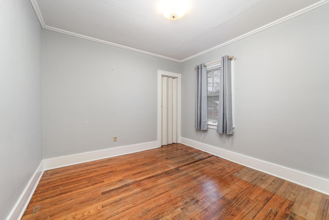 spare room featuring crown molding and hardwood / wood-style flooring