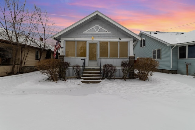 view of snow covered rear of property