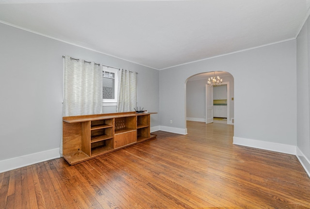 spare room featuring crown molding and wood-type flooring