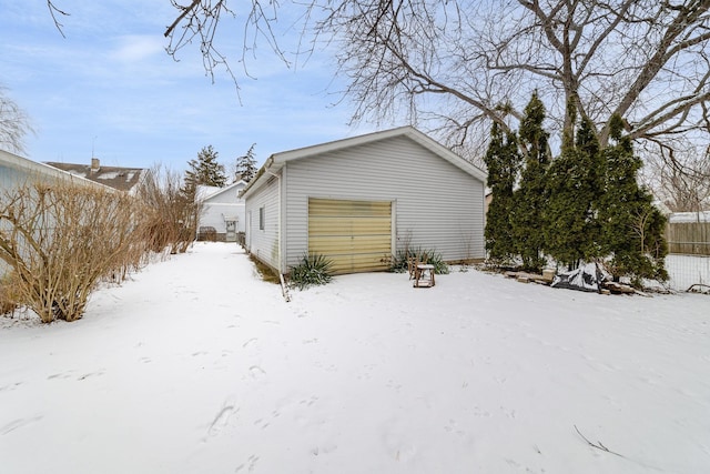 view of snowy exterior with a garage