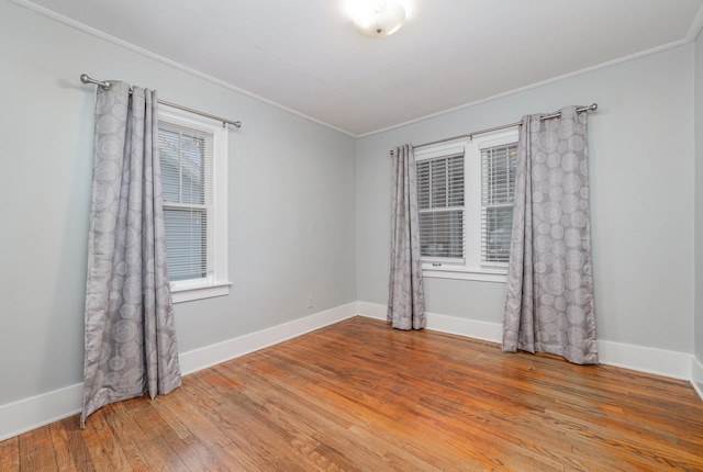 spare room featuring hardwood / wood-style floors and crown molding