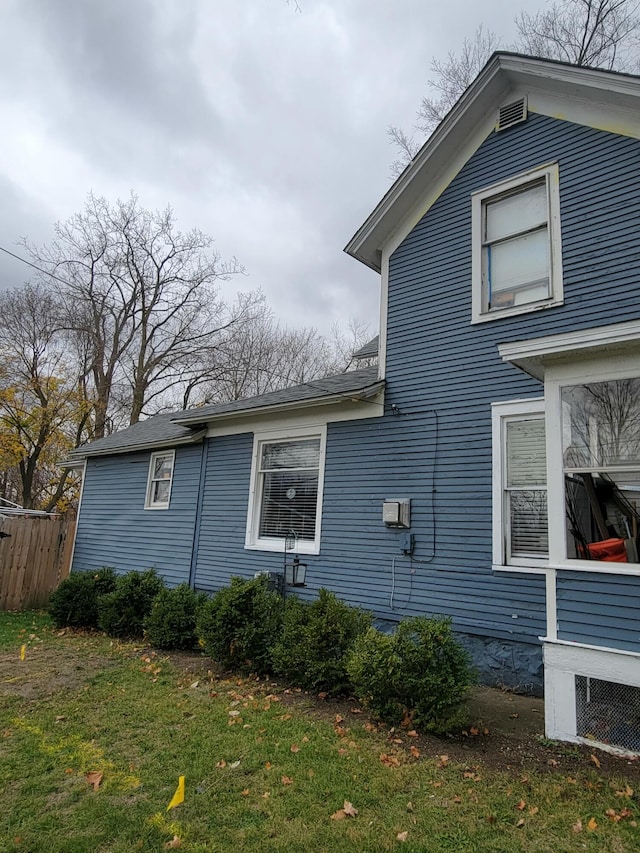 view of property exterior with a yard