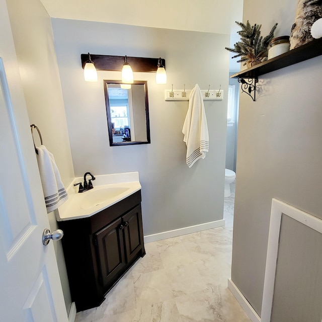 bathroom featuring vanity and toilet