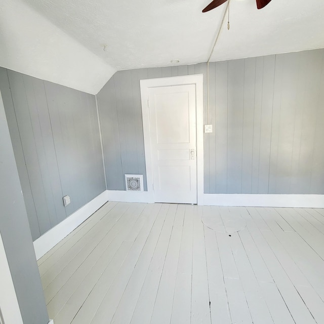 bonus room with wood-type flooring, ceiling fan, and vaulted ceiling