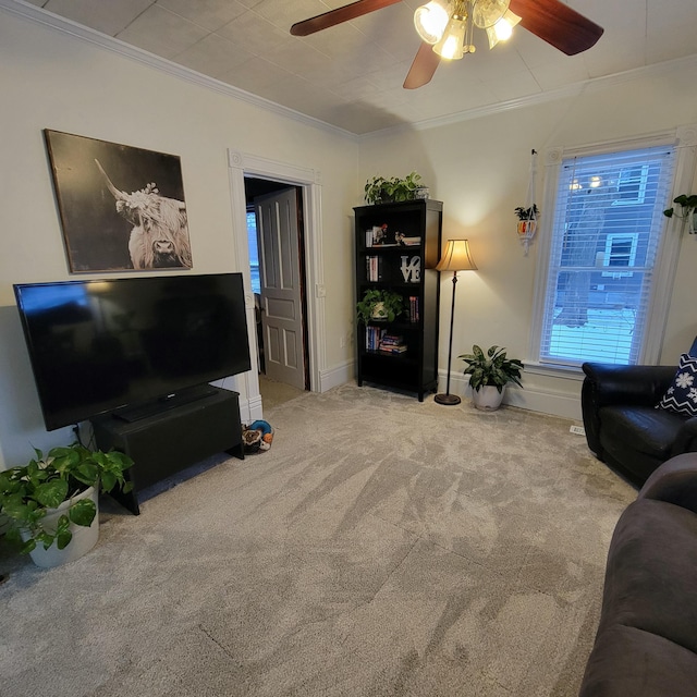 living room featuring ornamental molding, light carpet, and ceiling fan