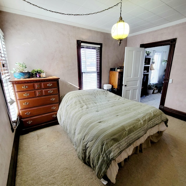 bedroom featuring crown molding and light carpet