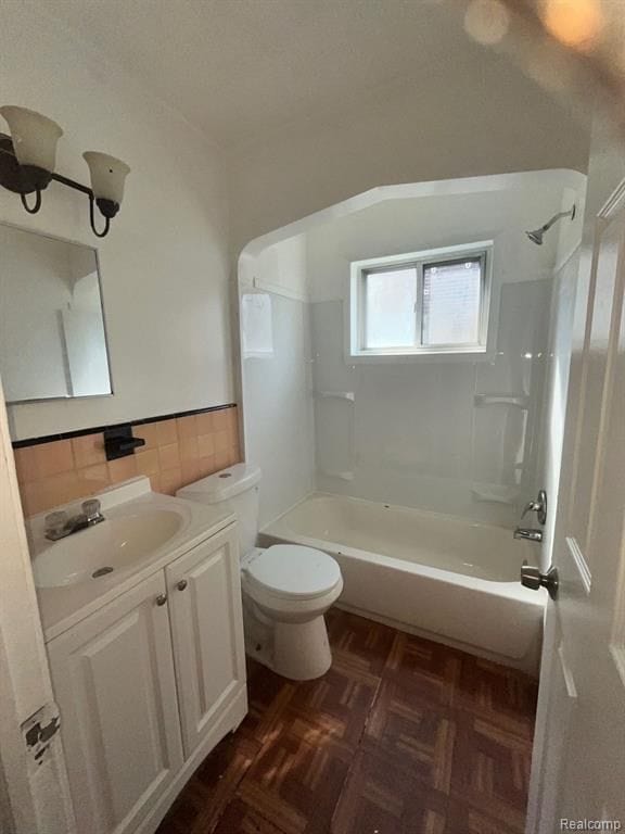 full bathroom featuring  shower combination, tile walls, vanity, parquet floors, and toilet