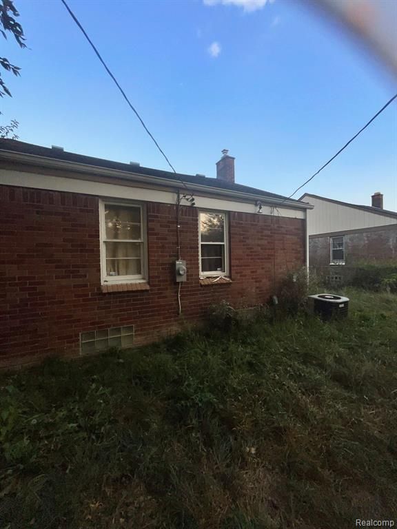 view of property exterior with central AC unit